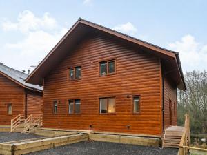 a log house with a gambrel roof at Waterside Lodge Four - Uk36706 in Southowram