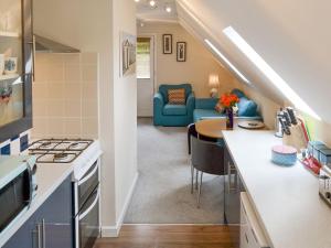 a kitchen and living room with a couch and a table at Oak View Loft - Uk11926 in Lessingham