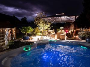 a hot tub in a backyard at night at The Bield in Aberfoyle