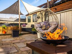 a hammock hanging over a fire in a yard at North & Back in North Walsham