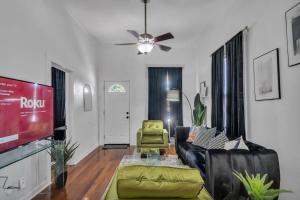 a living room with a couch and a tv at Heart of Ybor City 3bedroom walk to 7th ave in Tampa