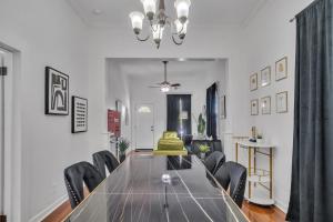 a dining room with a glass table and black chairs at Heart of Ybor City 3bedroom walk to 7th ave in Tampa