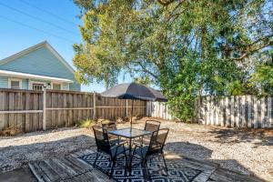 a patio with a table and chairs and an umbrella at Heart of Ybor City 3bedroom walk to 7th ave in Tampa