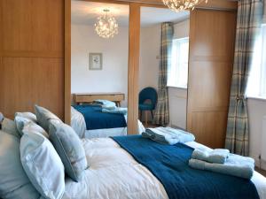 a bedroom with two beds with towels on them at Castle Holt in Otterburn