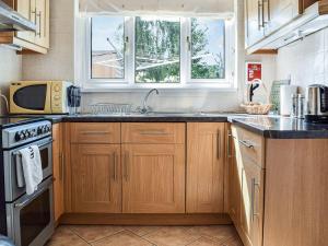 a kitchen with a sink and a microwave at Serenity Comfort in Sutton Coldfield