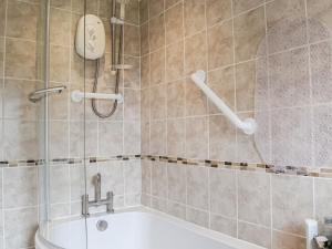 a bathroom with a shower and a bath tub at Serenity Comfort in Sutton Coldfield