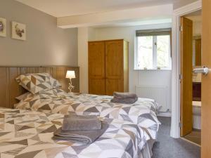 a bedroom with a bed with towels on it at The Loft in Holwell