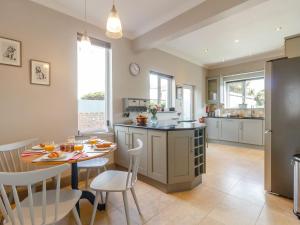 a kitchen with a table and a dining room at Court House in Porthcawl
