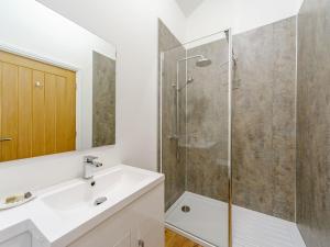 a bathroom with a sink and a shower at Merry Burn Barn - Uk3325 in Falstone