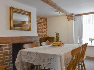 a table with a bowl of bananas on it at Holme Cottage in Eastry