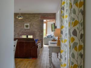 a kitchen and living room with a brick wall at Greenford Farm in Newtyle