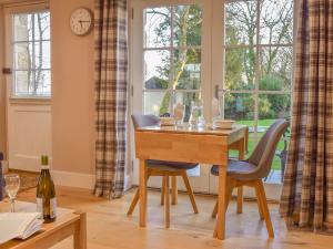 a dining room with a table and chairs and a window at Camelia Cottage-uk37205 in Sancreed