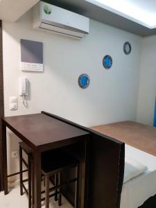 a room with a table and a bed and a phone at D&B Apartment 3 in Paralia Katerinis