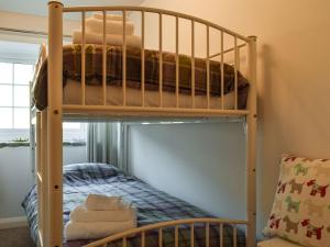 two bunk beds in a room with a bed at Barn House in Settle
