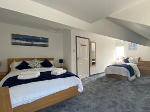 a large bedroom with two beds in it at The Oak Apartment in Brigham