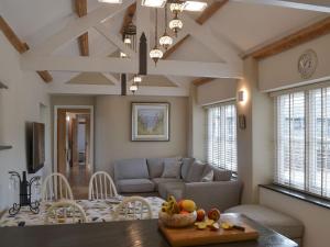 a living room with a couch and a table at Trezeal Barn in North Hill