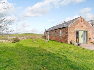 an old brick house on a grassy field at Abigails Cottage in Trimdon Grange