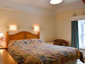 a bedroom with a large bed and a window at Hameldown-uk12423 in Widecombe in the Moor