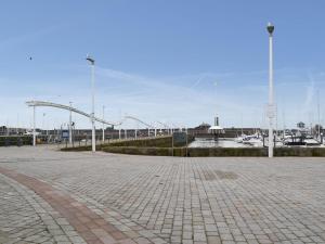 a parking lot with a pier and a marina with boats at Duncan Square in Whitehaven