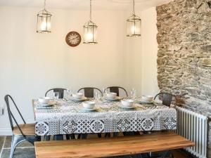 a dining room with a table and chairs at Conn Cottage in Bampton