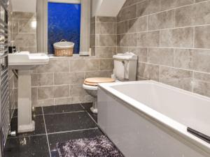a bathroom with a tub and a toilet and a sink at Stonebank Cottage - Uk35686 in Hunwick