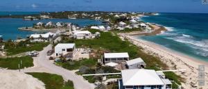 an aerial view of a beach with houses and the ocean at Rooster Beach - Hope Town, Elbow Cay in Lubbers Quarters Cay