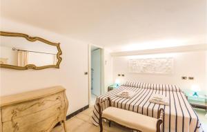 a white bedroom with a bed and a mirror at Girasole in San Michele di Pagana