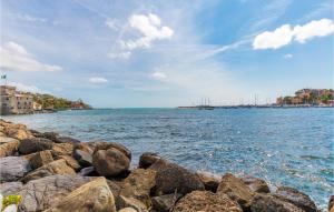 a group of rocks on the shore of a body of water at Girasole in San Michele di Pagana