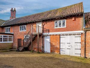 a brick house with a garage and a staircase at The Apple Store - Uk32623 in Swannington
