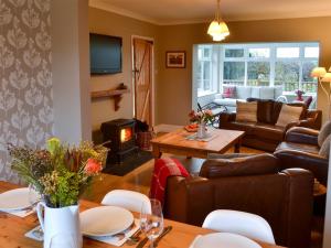 a living room with a couch and a table at Westfield Farm Cottage in Seaton Delaval