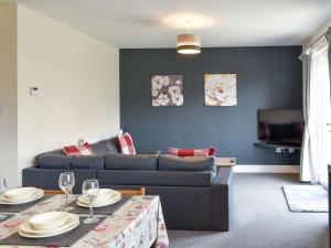 a living room with a couch and a table at Four Dorchester Drive - Uk32042 in Inglewhite