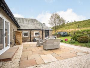 a patio with chairs and a house at The Liddel Haven - Uk35337 in Saughtree
