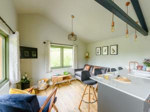 a kitchen and living room with a couch and a table at Glyn-Haul - UK32022 in Llanidloes