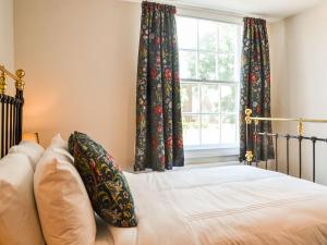 Schlafzimmer mit einem Bett und einem Fenster in der Unterkunft Hambleton House in Malton
