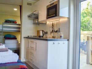 a kitchen with a counter and a sink in a room at Curlew in Westward