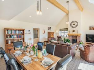 a living room with a wooden table and chairs at Lizzies Cottage in Skendleby