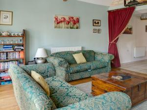 a living room with a couch and a table at Leonard Barn in Stonehouse
