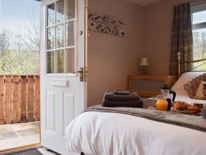 a bedroom with a bed with a tray of food on it at Pheasant Lodge in Staithes