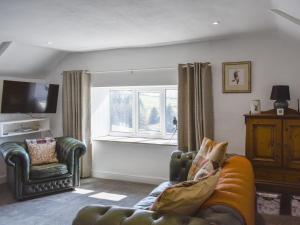 a living room with a couch and a window at Ramblers Rest - Uk33474 in Nenthead
