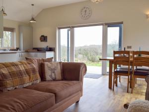 a living room with a couch and a table at Cadno - Uk32825 in Cwrt-newydd