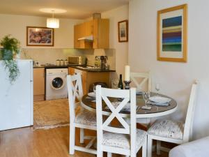 a kitchen and dining room with a table and chairs at Number 29 in Wooler