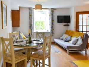 a living room with a table and a couch at Number 29 in Wooler