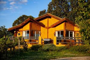 a yellow house with a car parked in front of it at Rose Cottage. Cosy, eco-friendly cottage in Yarra Glen. in Yarra Glen