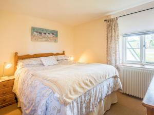 a bedroom with a bed and a window at Well Farm Cottage - Uk11879 in North Tamerton