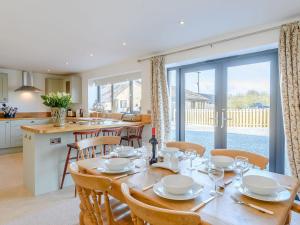 a kitchen and dining room with a table and chairs at The Lodge in Upton Bishop