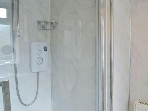 a shower in a bathroom with a glass shower backdoor at Tigh Beag in Troon