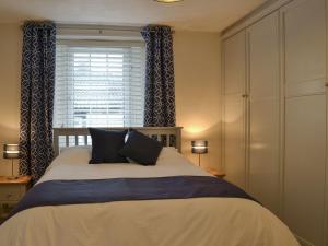 a bedroom with a large bed and a window at Little Nook in St Bees