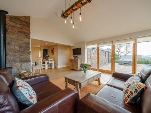 a living room with a couch and a table at Tyr Ywen Cottage in Abergavenny