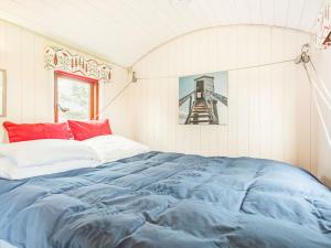 a bedroom with a blue comforter on a bed at Foxglove in Ancroft