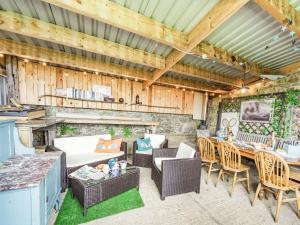 an outdoor patio with wicker furniture and a table at Foxglove in Ancroft
